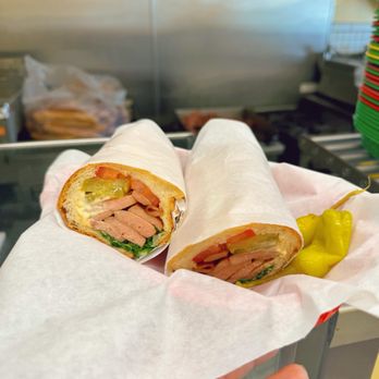 Glendale Cafe - a hand holding a sandwich wrapped in paper - Sandwiches Near Me - Glendale, California