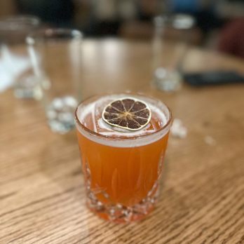 Dram And Draught - a shot of a drink on a table - Bars Near Me - Winston-Salem, North Carolina