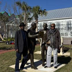 Explore Jax Core - Janice and Fred posing with James Weldon Johnson and his brother John Rosamond Johnson statues.