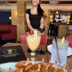 Joint Base McGuire-Dix-Lakehurst Passenger Terminal - Coconut crusted shrimp appetizer, piña colada--hand-crafted cocktail, our server.