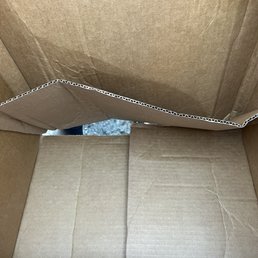 Big hole in box, no padding or packing material used Big hole in box, no padding or packing material used