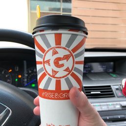 a hand holding a coffee cup a hand holding a coffee cup
