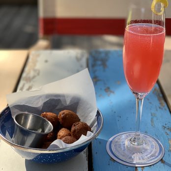Perla's - Hibiscus Breeze cocktail and some fritters - Seafood Near Me - Austin, Texas Perla's - Hibiscus Breeze cocktail and some fritters - Seafood Near Me - Austin, Texas