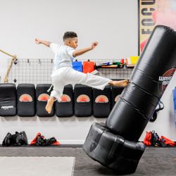 Sun Martial Arts - Foundations of Black Belt Program. Student demonstrating flying kick