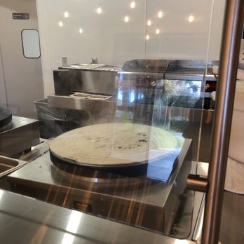 Creative Crepes - a pizza being prepared in a commercial kitchen - Creperies Near Me - Rosemary Beach, Florida