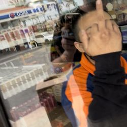 Arco Gas Station - An employee flipping me off after she pulled a knife on me