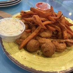 Fried shrimps and sweet potato fries. Fried shrimps and sweet potato fries.