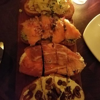 Postino Annex - Top to bottom: Artichoke, smoked salmon with pesto , prosciutto with figs, riccotta with dates and pistachio. - Wine Bars Near Me - Tempe, Arizona Postino Annex - Top to bottom: Artichoke, smoked salmon with pesto , prosciutto with figs, riccotta with dates and pistachio. - Wine Bars Near Me - Tempe, Arizona