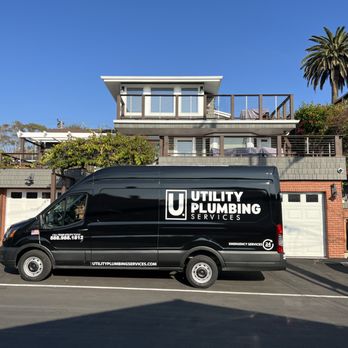 Utility Plumbing Services - Utility Plumbing services work van in front of a residential home ready to install a tankless water heater - Plumbing Near Me - Rancho Cucamonga, California