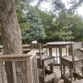 Spirit Knob Winery - a table and chairs on a deck - Wineries Near Me - Ursa, Illinois