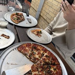 Cauliflower pizza (closer to camera) and regular crust pizza. Cauliflower pizza (closer to camera) and regular crust pizza.