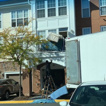Around Town Movers - Furniture being passed over the deck - Movers Near Me - Sterling, Virginia