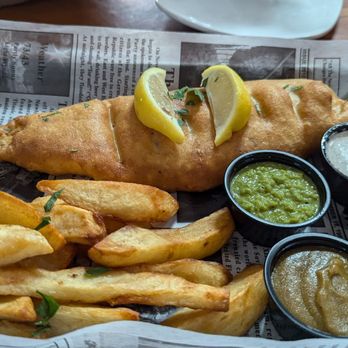 The Kenney Fort British Pub - Fish and chips meal with sauces. Including a delish curry sauce. - Pubs Near Me - Round Rock, Texas The Kenney Fort British Pub - Fish and chips meal with sauces. Including a delish curry sauce. - Pubs Near Me - Round Rock, Texas