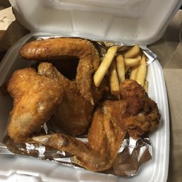 chicken and french fries in a styrofoam container chicken and french fries in a styrofoam container