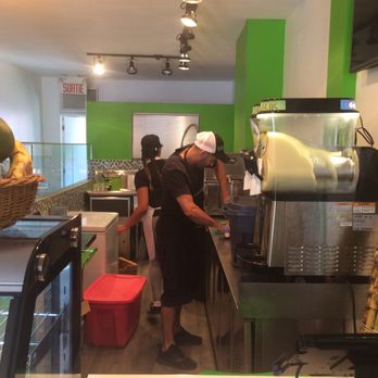 Les Jus Kanasuk - a man preparing food in a kitchen - Bars Near Me - Montreal, Quebec Les Jus Kanasuk - a man preparing food in a kitchen - Bars Near Me - Montreal, Quebec