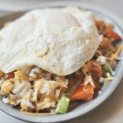 Molly Brown's Country Cafe - Mexican Skillet. Fried potatoes, mixed vegetables, Ortega chiles, lean machaca, and melted cheddar cheese. Eggs on top.