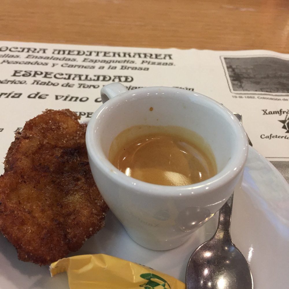 Xamfrà Gaudí - Espresso served with a piece of fried pastry - Spanish Near Me - Barcelona, B Xamfrà Gaudí - Espresso served with a piece of fried pastry - Spanish Near Me - Barcelona, B