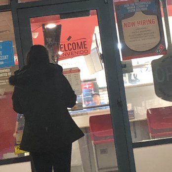 Domino's Pizza - a woman standing in front of a door - Pizza Near Me - Romeoville, Illinois