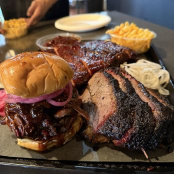 Horn Barbecue - Brisket sandwich, sliced brisket, spare ribs, beans, Mac n cheese stacked nice and neat by the employees. - Desserts Near Me - Lafayette, California Horn Barbecue - Brisket sandwich, sliced brisket, spare ribs, beans, Mac n cheese stacked nice and neat by the employees. - Desserts Near Me - Lafayette, California