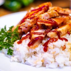 Chicos Chicken - Chicken served over rice with a side of macaroni salad.