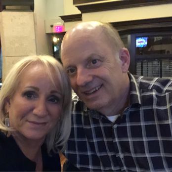 Harry & Izzy's - Jeff & Patty sitting sitting at the bar, kissing - Steakhouses Near Me - Indianapolis, Indiana