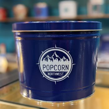 Popcorn Northwest - a blue bucket with a logo on it - Popcorn Shops Near Me - Richland, Washington Popcorn Northwest - a blue bucket with a logo on it - Popcorn Shops Near Me - Richland, Washington