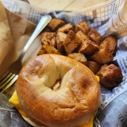 Egg and cheese bagel with side of home fries Egg and cheese bagel with side of home fries