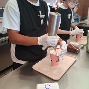 Molly Tea - the one on the left as he pour the whipped cream layer with crush pecans - Bubble Tea Near Me - Santa Clara, California