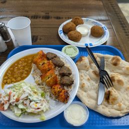 Chicken and lamb combo plate with am extra side of falafel. Chicken and lamb combo plate with am extra side of falafel.