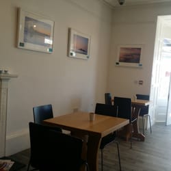 Cafe Limelight - Simple tables in the cafe area, with door leading to outside terrace