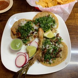 Carne asada, al pastor and chorizo tacos with grilled onions. Carne asada, al pastor and chorizo tacos with grilled onions.