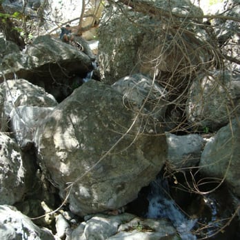 Solstice Canyon - huge boulders. perspective: that's my friend at the top left - Parks Near Me - Malibu, California