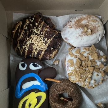 Voodoo Doughnut - Yum. It is a Banana Cream Pie, voodoo Voodoo Doll, Eggnog Gingersnap, chili pepper and cinnamon donut, and an Old Dirty Bastard fritter. - Donuts Near Me - Tempe, Arizona