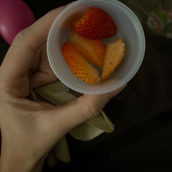 Menchie's Frozen Yogurt - a person holding a bowl of fruit - Ice Cream & Frozen Yogurt Near Me - Gainesville, Florida
