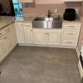 Queen Monarch Design - a kitchen with white cabinets and a stainless steel sink - Flooring Near Me - Imperial, Missouri Queen Monarch Design - a kitchen with white cabinets and a stainless steel sink - Flooring Near Me - Imperial, Missouri