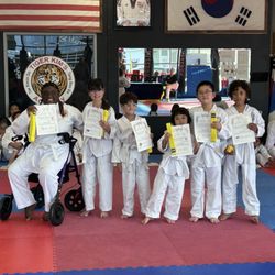 Tiger Kim's Academy - Tiger Kim's Academy students display their latest achievement with their new belts and diplomas