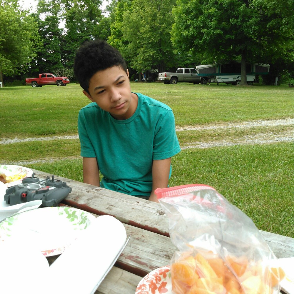 Sand Creek Campground - My son at our camp table on their lush grounds - Campgrounds Near Me - Chesterton, Indiana Sand Creek Campground - My son at our camp table on their lush grounds - Campgrounds Near Me - Chesterton, Indiana