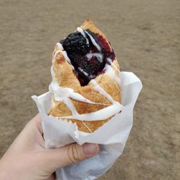 a hand holding a pastry