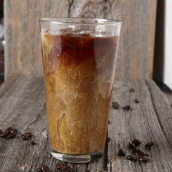 Coffee Time - a glass of iced coffee on a wooden table - Coffee & Tea Near Me - Stayner, Ontario