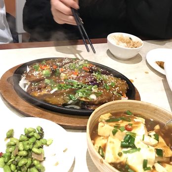 Chez Chen - a woman eating a meal at a restaurant - Chinese Near Me - Montreal, Quebec