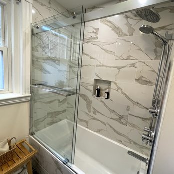 YD construction - a bathroom with a shower and tub - General Contractors Near Me