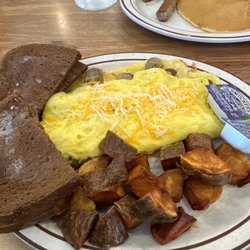 Egg-Cetera Cafe - Sausage omelette with what appears to be deep fried potatoes , rye toast with a side of small cakes and sausage $30 ???