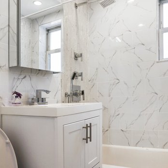 Emile's Amenities - For this job, we replaced all the wall tiles, the shower body, the sink/vanity/ mirror and added high hat lights. - General Contractors Near Me Emile's Amenities - For this job, we replaced all the wall tiles, the shower body, the sink/vanity/ mirror and added high hat lights. - General Contractors Near Me