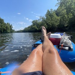 Wilderness Canoe Company - Feet resting on the Cooler Float