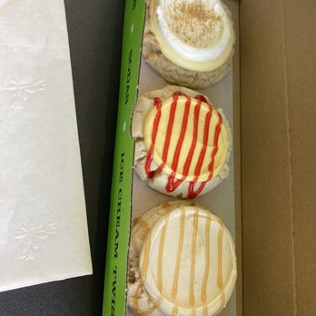 Twisted Sugar - Three cookies with different toppings and drizzles are arranged in a cardboard box, each with a distinct appearance and flavor. - Desserts Near Me - Provo, Utah