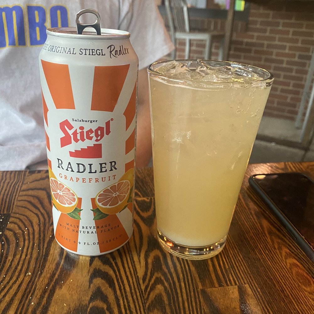 The Walnut Room - a can of stiegt radler next to a glass of orange juice - Pizza Near Me - Denver, Colorado The Walnut Room - a can of stiegt radler next to a glass of orange juice - Pizza Near Me - Denver, Colorado