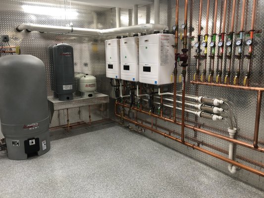 New Boiler Installation in a 10,000 Sq. Ft. Home - it is a huge 10,000 square-foot home. The homeowner wanted to use nothing but radiant floor heating. We installed three boilers that rotate and do not work at the same time along with a 80 gallon indirect water heater. The floor heating has been amazing and warms up the entire home very quickly.