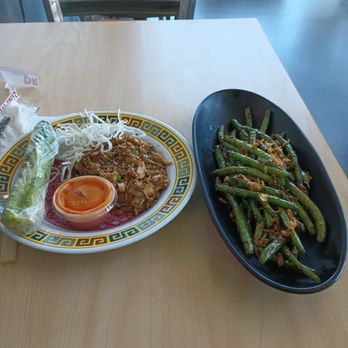 Tin Drum Asian Kitchen & Boba Tea Bar - Sandy Springs - Chicken wrap on the left and green beans on the right - Asian Fusion Near Me - Sandy Springs, Georgia Tin Drum Asian Kitchen & Boba Tea Bar - Sandy Springs - Chicken wrap on the left and green beans on the right - Asian Fusion Near Me - Sandy Springs, Georgia