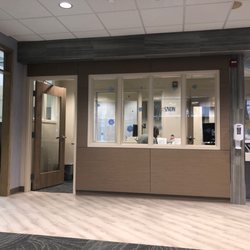 Patient First Primary & Urgent Care - Falls Church - Reception desk with digital check in screens