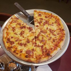 Tony's Cafe & Pizzeria - Bacon and pineapple.  New York Style.  Is delicious as well though I prefer Chicago style.